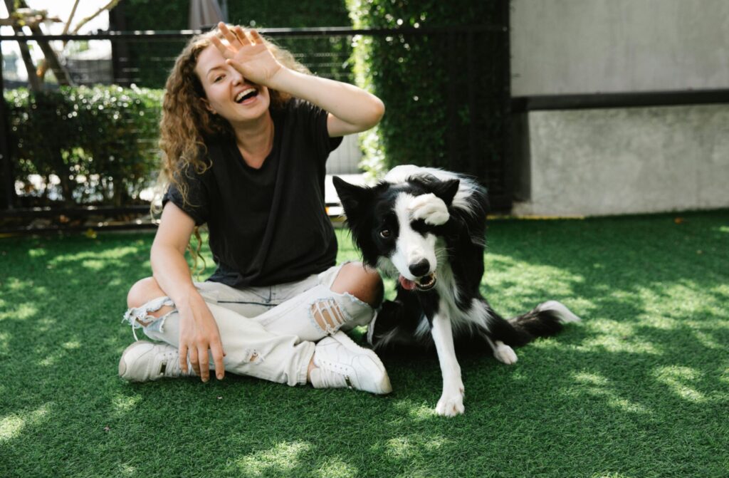 Dog walker taking a happy dog for a walk in the park.