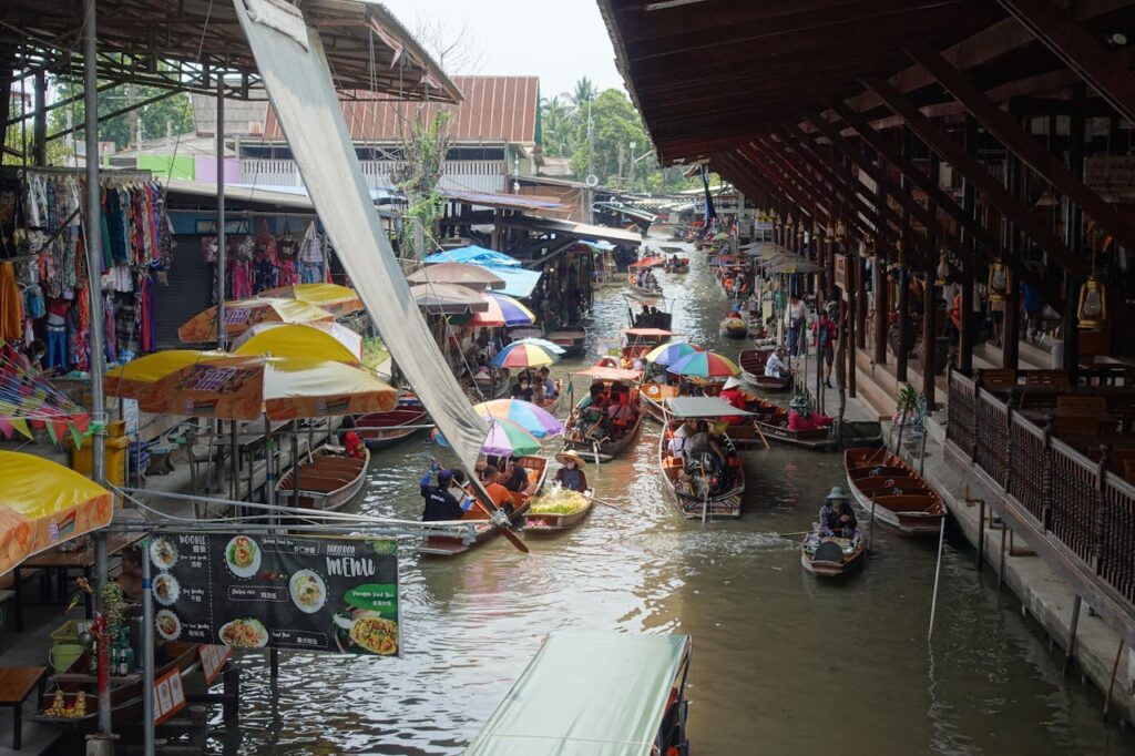 traditional floating market in thailand with food vendors